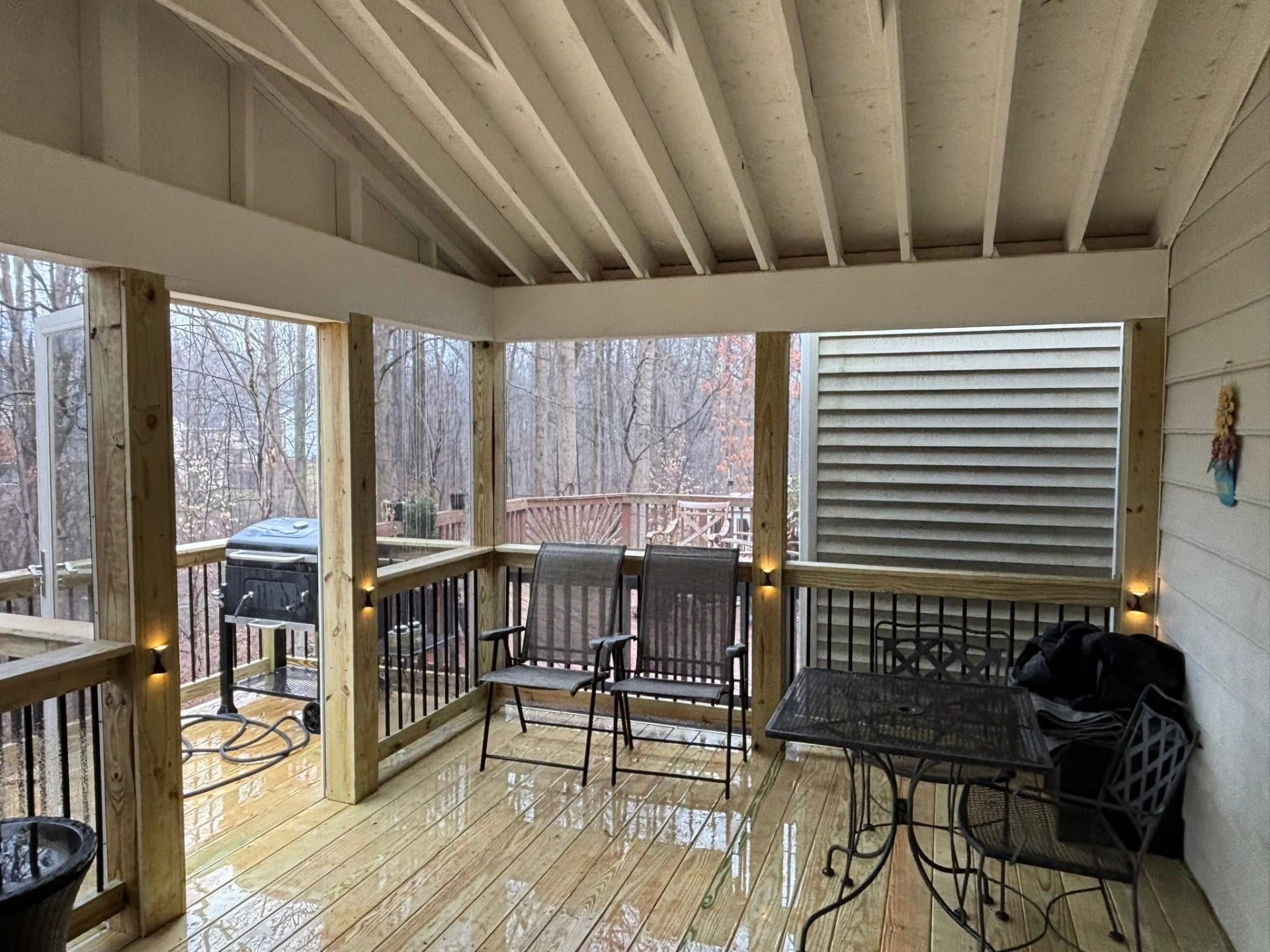 Screened porch with natural wood floors