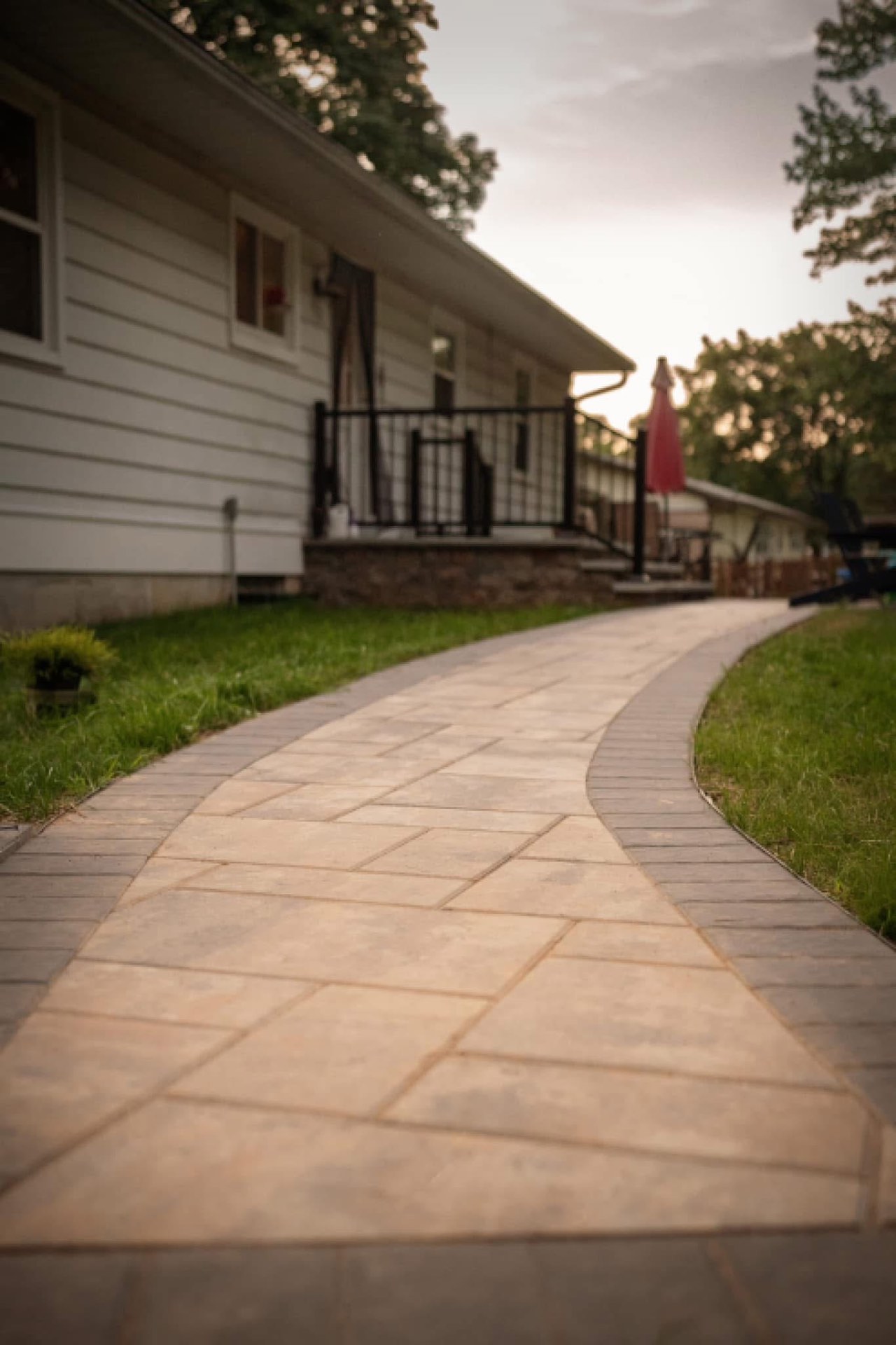 Curved paver walkway at dusk