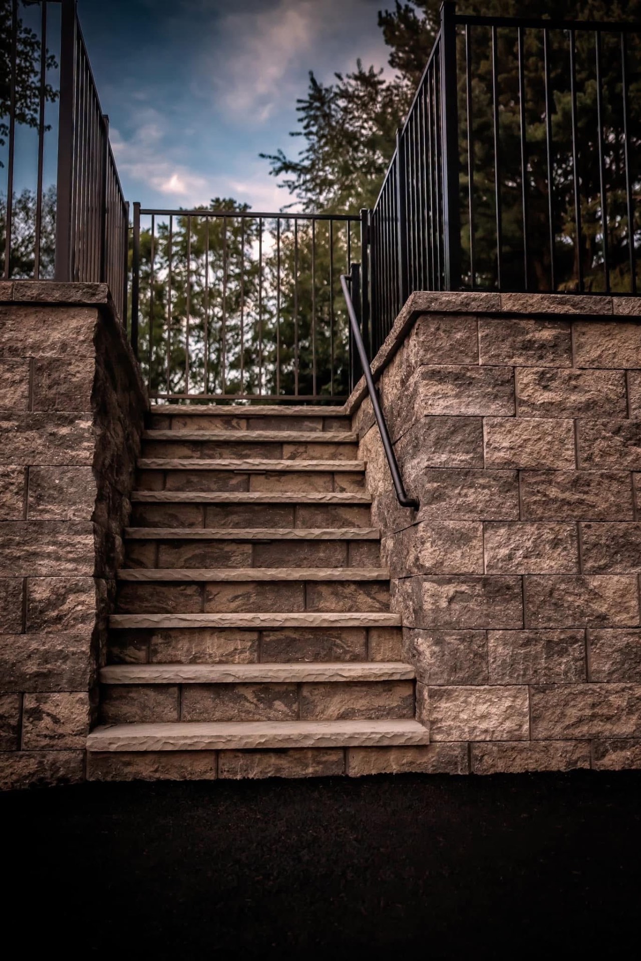 Custom stone stairway with iron railings