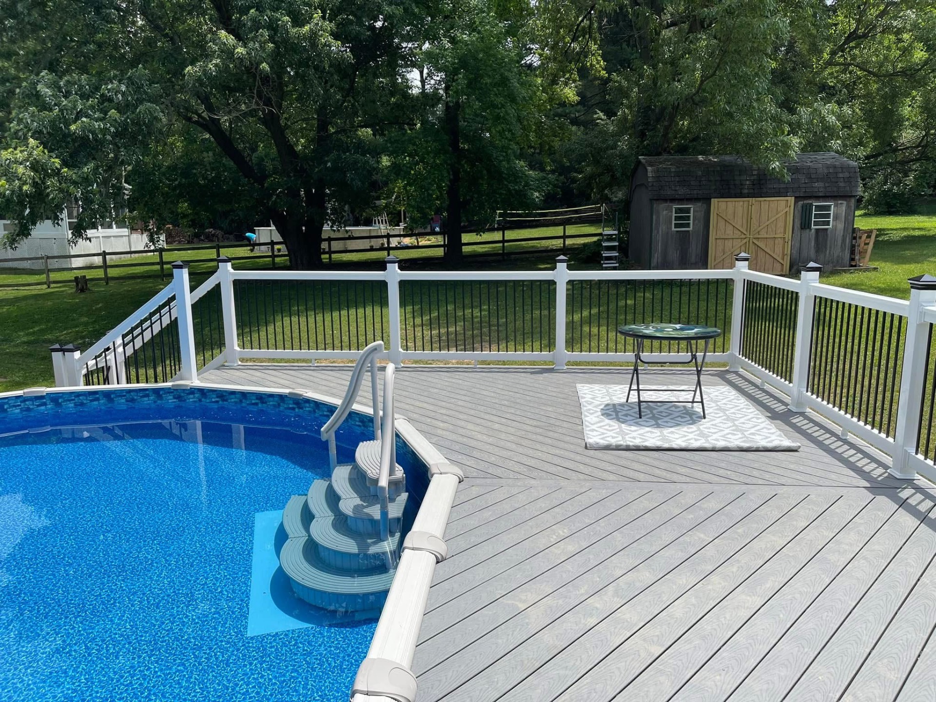 Pool-side composite deck with aluminum railing