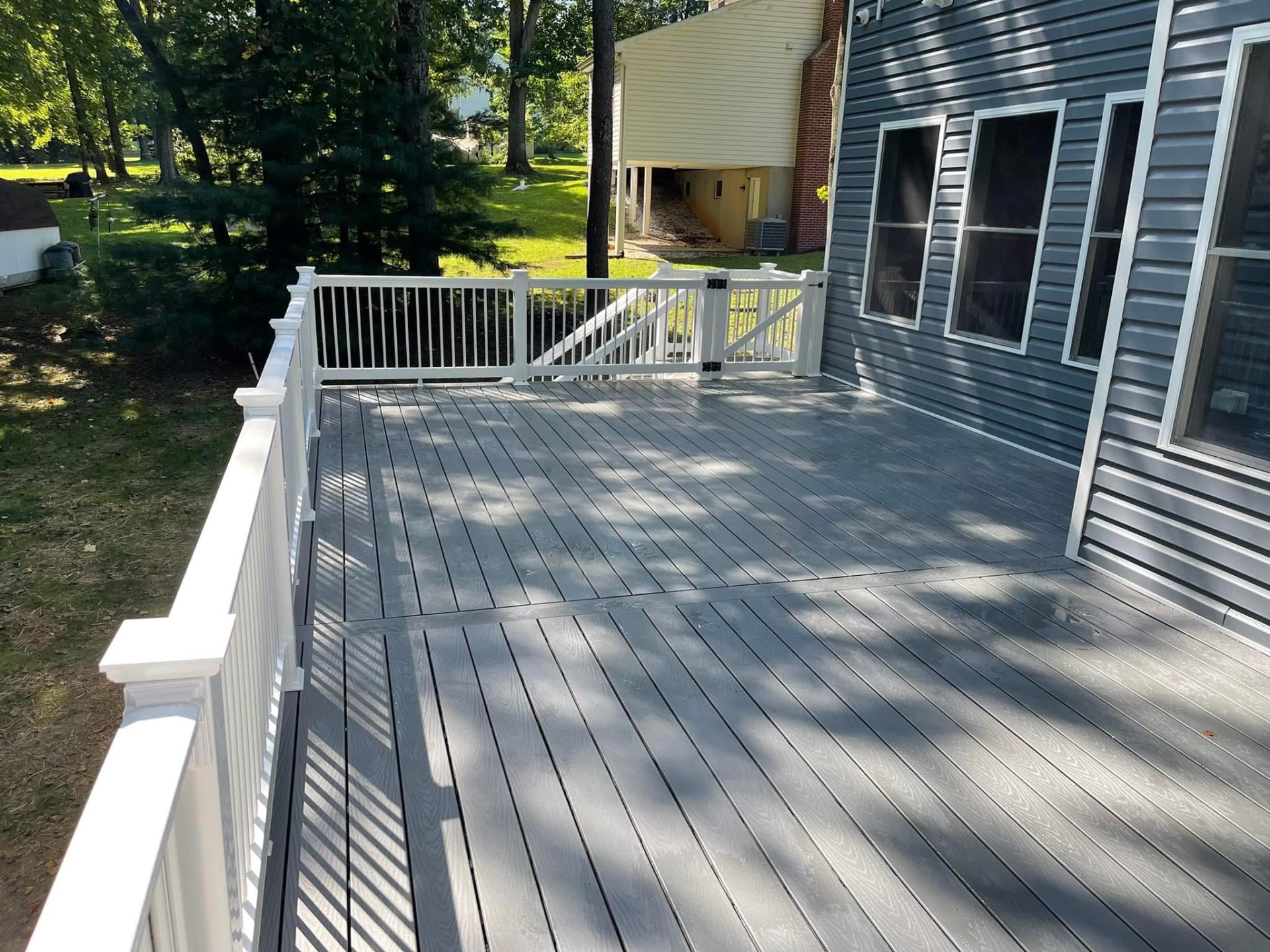 Gray composite deck with white vinyl railing