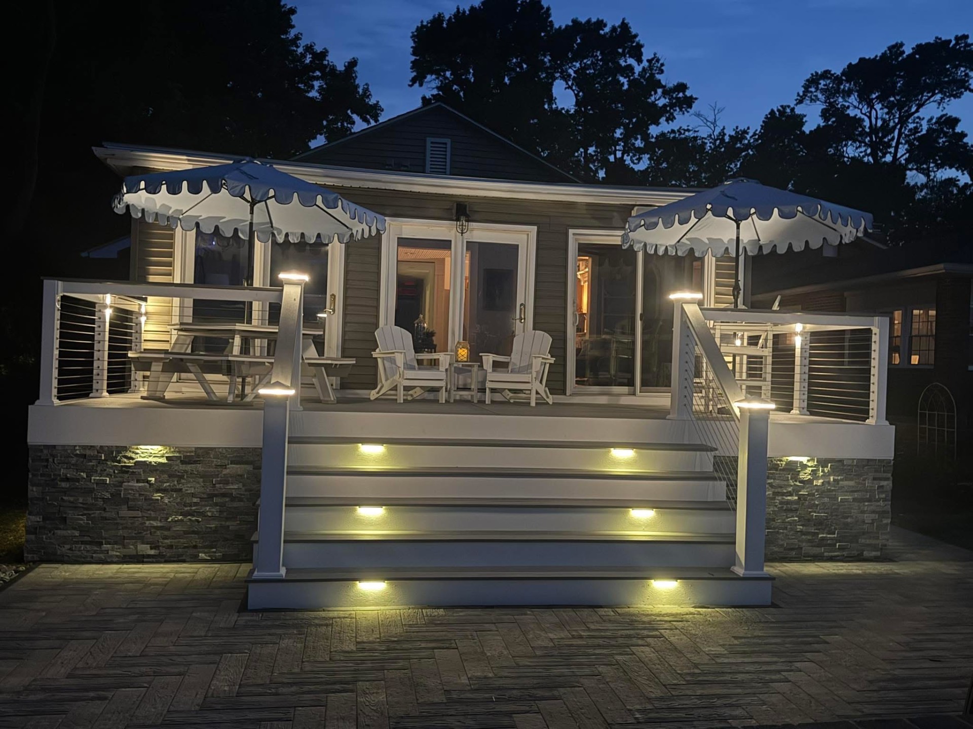Evening deck with cable railing and lighting